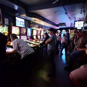 Large line of pinball machines and players
