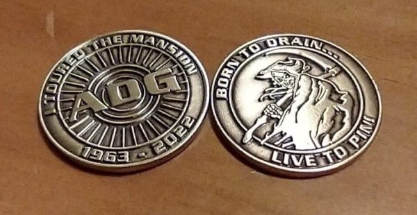 Two tokens with the image of a grim reaper and the initials "ADG"